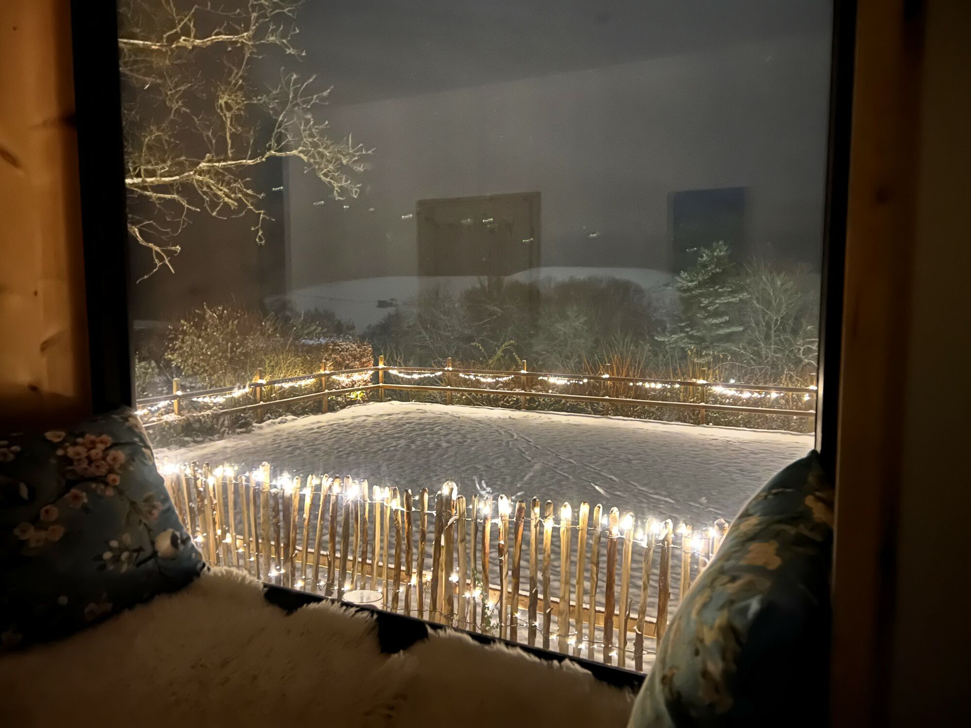 Ein Sitzfenster aus Zirbenholz im Landchalet Eifel auf dem Landgut Pfauenhof gibt den Blick auf eine wunderbare Landschaft frei.